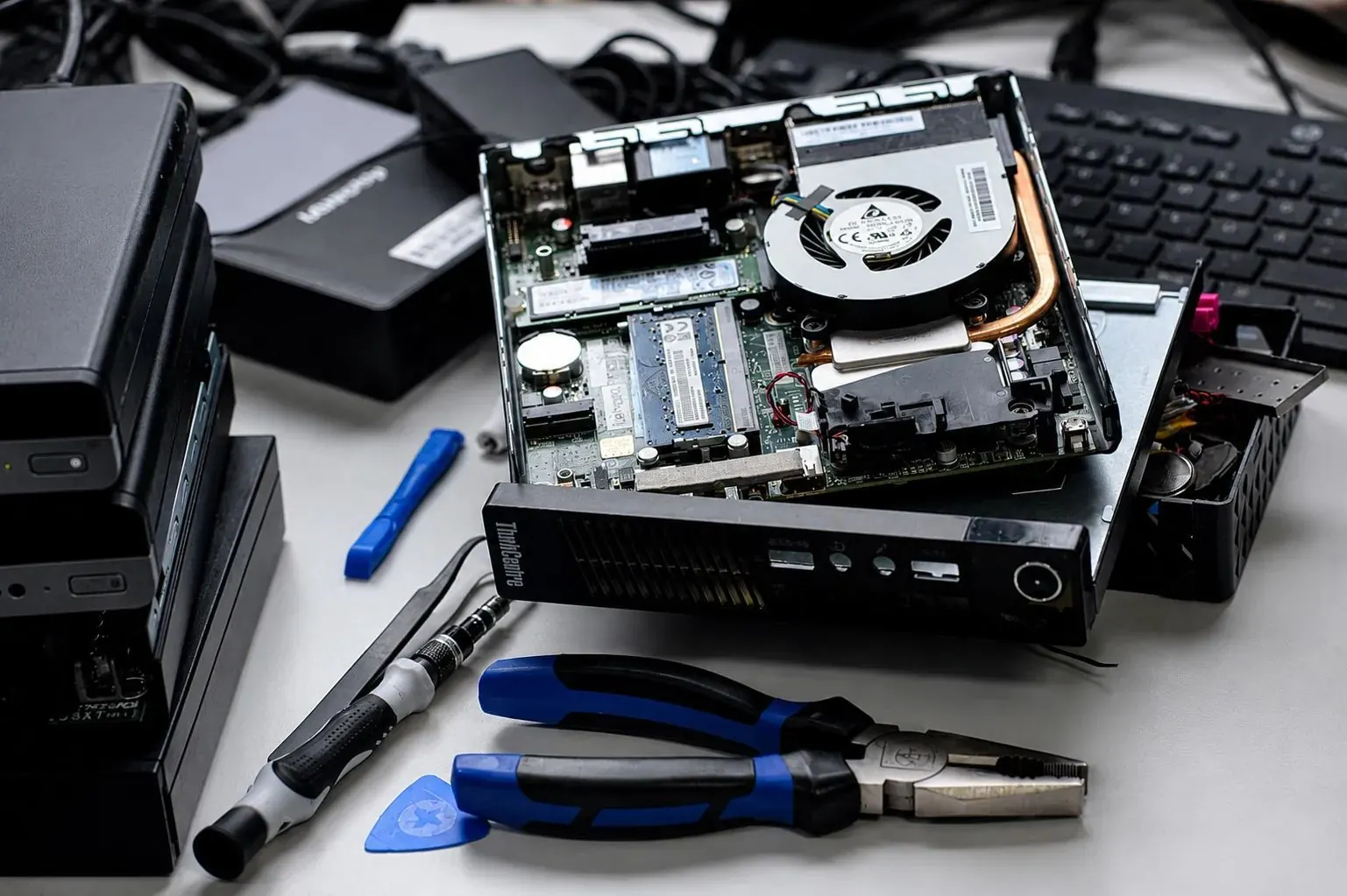 A mini PC opened up on the bench for testing